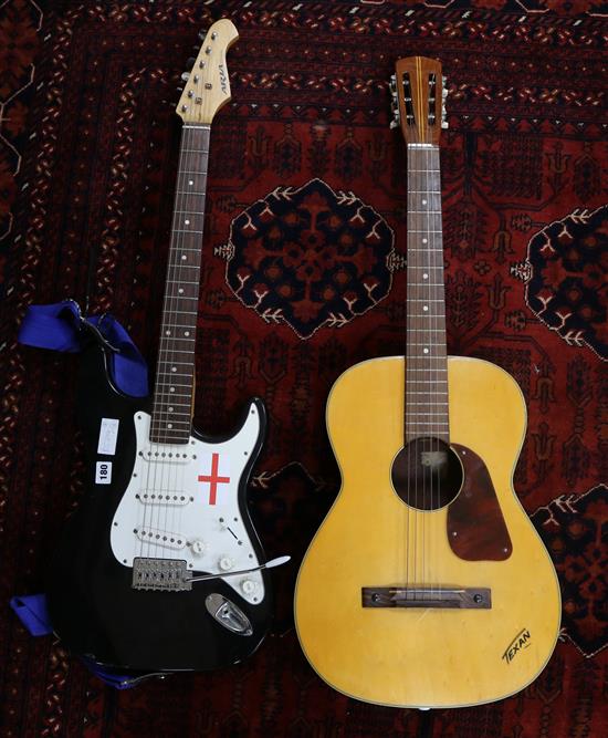 An Aria STG Series electric guitar and a Texan acoustic guitar